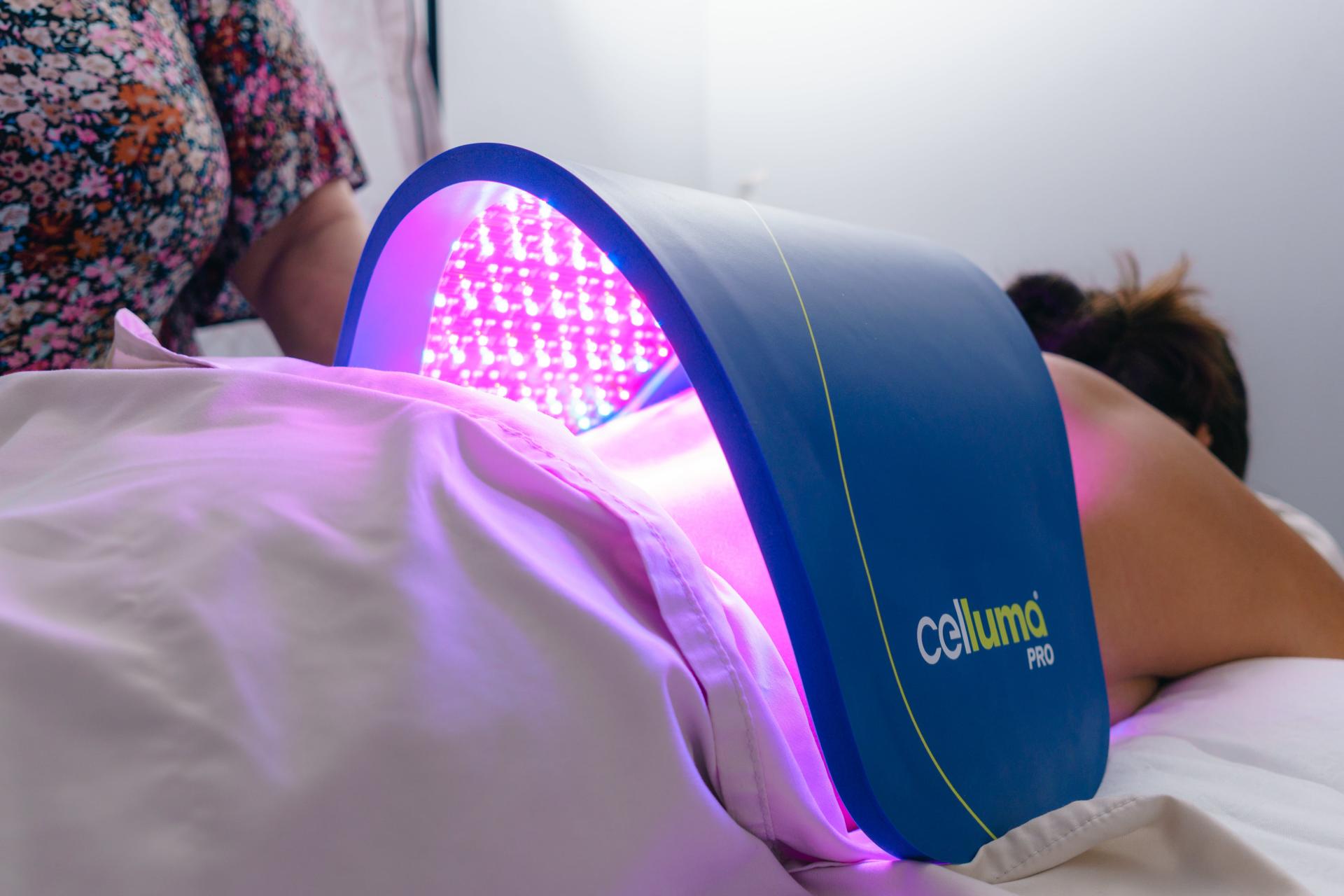 happy relaxed woman receiving celluma LED treatment 