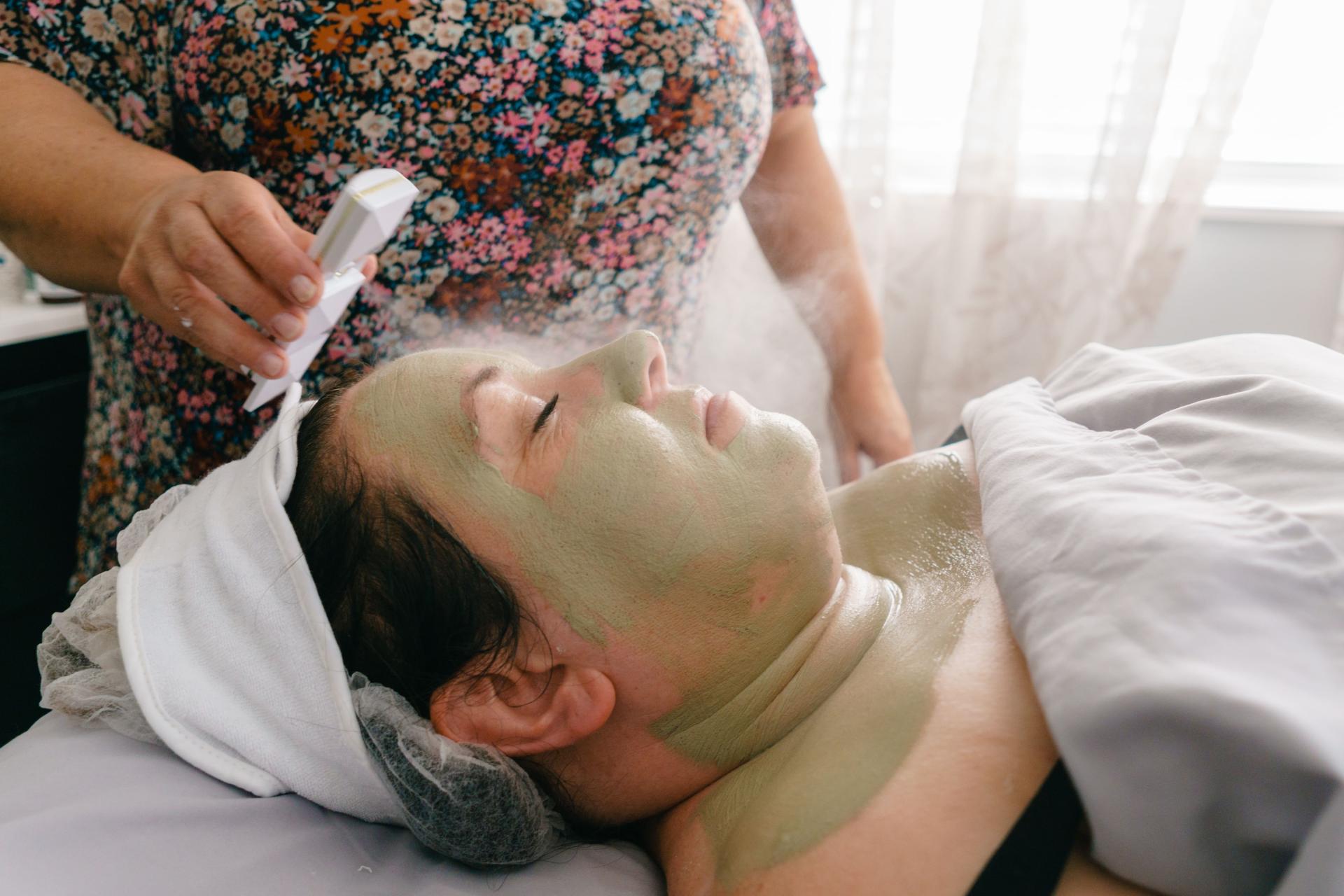 relaxed woman receiving facial skin therapy